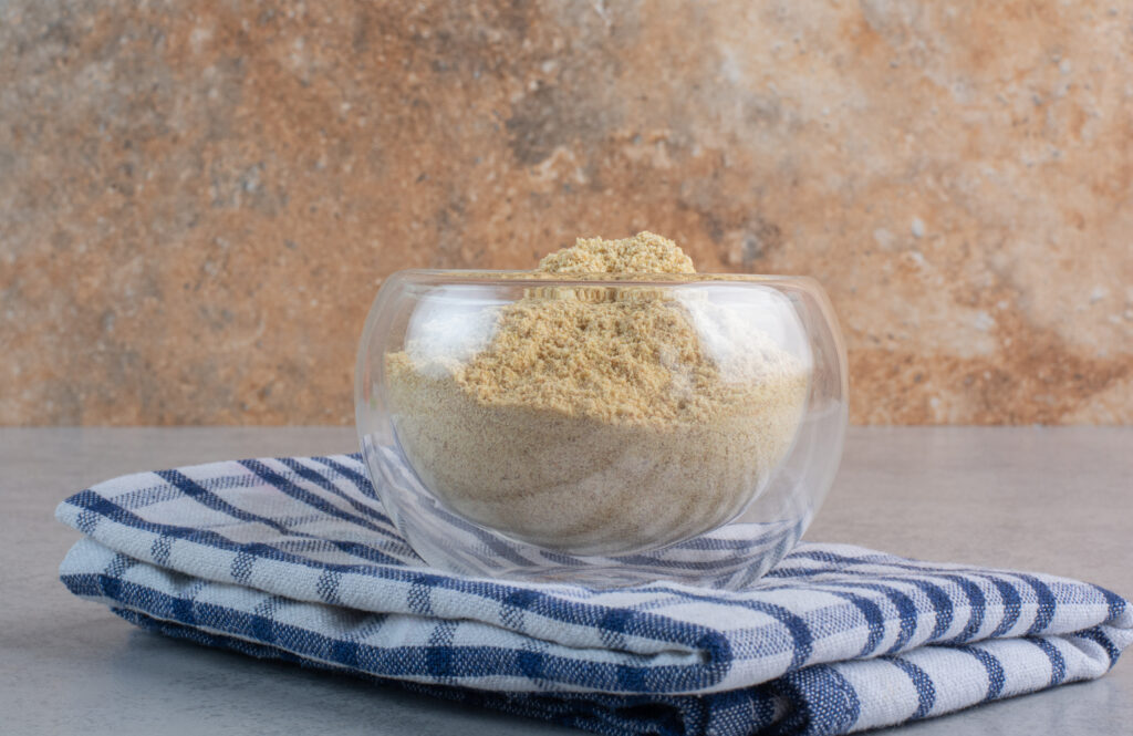 A focused shot of dried yeast granules, illustrating the difference in texture from fresh yeast. Whether active dry or instant, these dormant yeast cells offer consistency and a long shelf life, making them ideal for managing long 48-hour cold fermentations in a home kitchen.