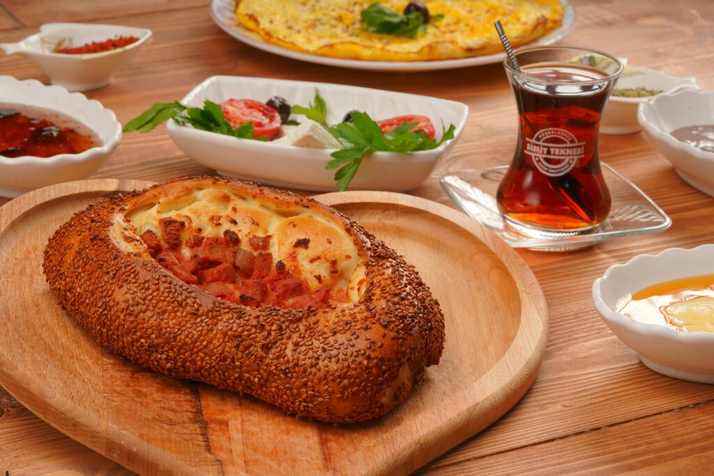 Authentic Turkish breakfast featuring sesame pide, salad, and traditional tea.